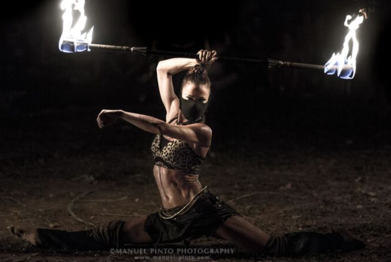 A fire dancer at Envision twirls her flaming staff. Photo courtesy of Manuel Pinto Photography